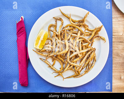 Pescaito frito, fried fish Andalusian style on a tavern table. Spanish cookery.