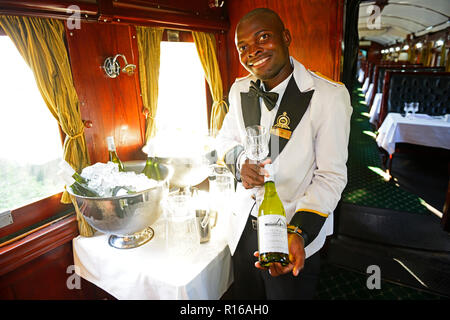Service staff with wine selection in luxury train, Royal Livingstone Express, Livingstone, Zambia