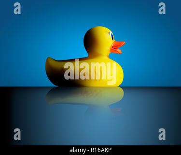 Yellow rubber duck against blue background, side view Stock Photo
