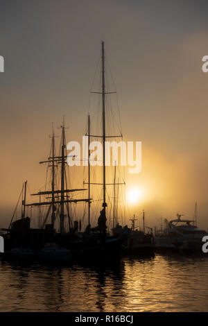 Ships silhouetted against dawn sky in Poole Stock Photo - Alamy
