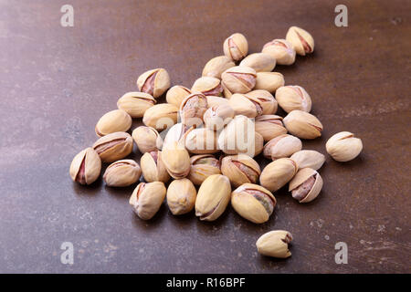 Salt pistachios on a stone table. Close-up. Stock Photo