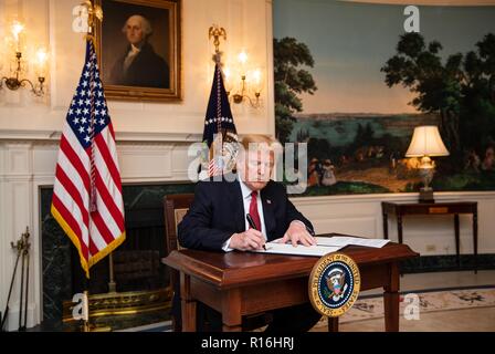 Washington, United States Of America. 09th Nov, 2018. U.S President Donald Trump signs an Immigration Proclamation declaring that migrants seeking asylum along the southern border must present themselves lawfully at a port of entry in the Diplomatic Reception Room of the White House November 9, 2018 in Washington, DC. The order runs counter to current U.S. Immigration Law and International Treaties and is expected to be challenged in Federal Court. Credit: Planetpix/Alamy Live News Stock Photo