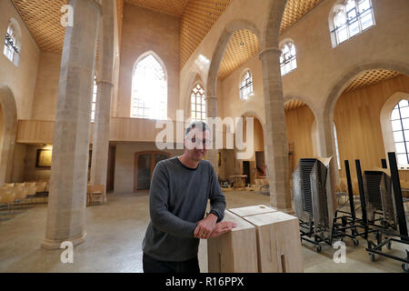 08 November 2018, Bavaria, Nürnberg: Georg Rieger, coordinator of the reconstruction of the church St. Martha, stands in the renovated building at the pulpit. After a fire with damage running into millions in June 2014, the Nuremberg Church of St. Martha reopens on 10 November. During the fire, the roof of the main nave was completely burnt down and parts of the building were in danger of collapsing. Photo: Daniel Karmann/dpa Stock Photo