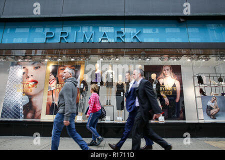 Shoppers are seen outside Primark store on London's Oxford Street. The retail sector faces difficulties as consumers cut down on spending and do more of their shopping online. A report by accountancy firm PWC has said that over 1,000 stores disappeared from Britain's top 500 high streets in the first six months of the year. Stock Photo