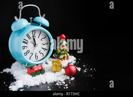 Alarm clock and new year decorations on black background Stock Photo