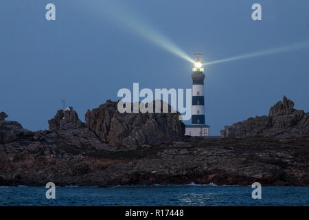 Powerful lighted lighthouse at dusk, creach point, ushant island, france Stock Photo
