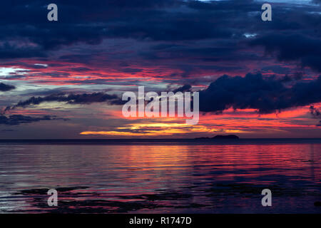 Dramatic sunset in Siquijor in the Philippines under heavy stormy cloud cover the horizon Stock Photo