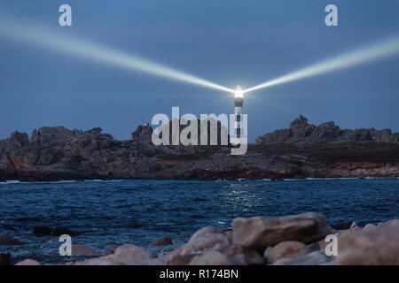 Powerful lighted lighthouse at dusk, Creach point, Ushant island, France Stock Photo