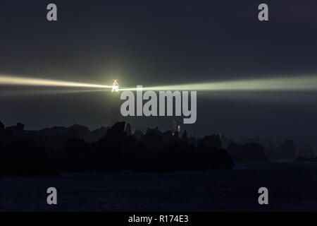 Lighted very powerful lighthouse in full night Stock Photo