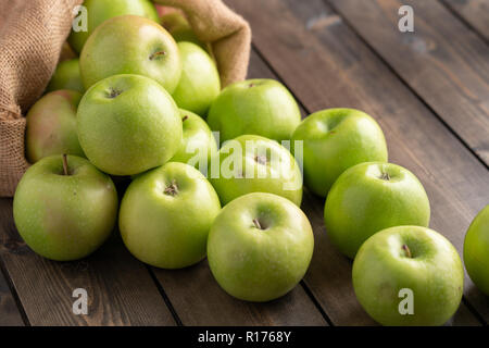 Green apples on wooden table Stock Photo