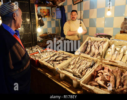 Fish vendor in the vibrant market in Fes, Morocco. Stock Photo