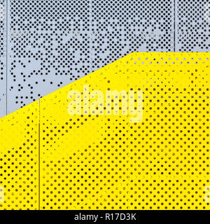 Grey and yellow perforated industrial metal background, abstract dotted texture Stock Photo