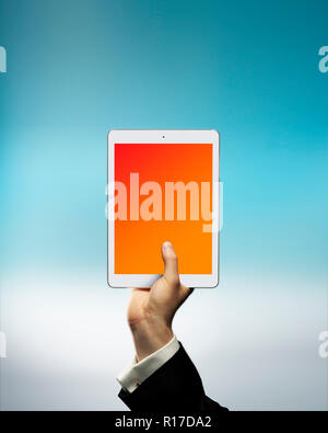 Businessman's hand holding digital tablet above cloud, cloud storage Stock Photo