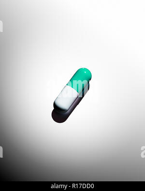 Green and white medication pill capsule, still life Stock Photo