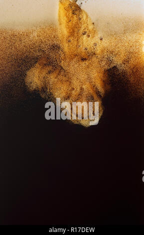 Frothing creamy beer head of draught guinness/dark beer being poured, close up detail Stock Photo