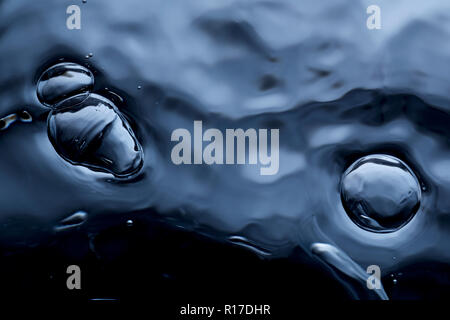 Air bubbles on dark water surface, close up detail Stock Photo
