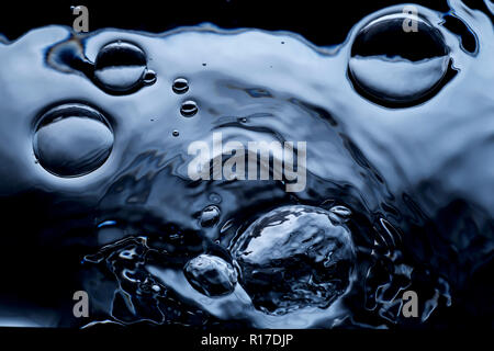 Air bubbles on dark water surface, close up detail Stock Photo