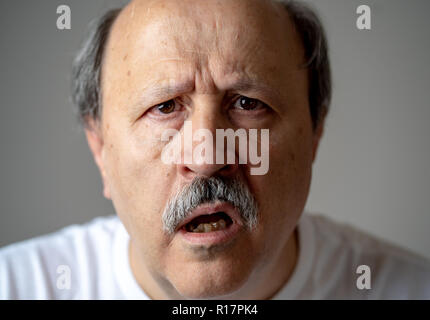 Close up portrait of senior man looking confused and lost suffering from dementia, memory loss or Alzheimer in Mental health in Older Adults and later Stock Photo