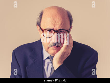 Close up portrait mature bald business man on his 60s feeling sad and worried dementia in Elderly people still working Alzheimer disease Mental diseas Stock Photo