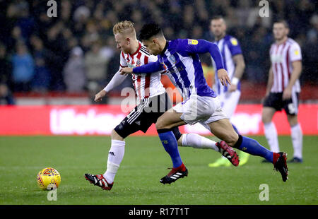 Sheffield United's Mark Duffy (left) and Sheffield Wednesday's Joey Pelupessy battle for the ball during the Sky Bet Championship match at Bramall Lane, Sheffield. Stock Photo