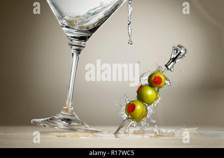 Cocktail splash in martini glass over black background with copy by Jelena  Jovanovic