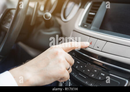 presses the emergency stop button in the car Stock Photo