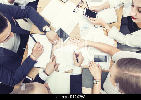 Group of business meeting at the table in the modern office of an office building,Team work and diverse hands together joining business relationships  Stock Photo