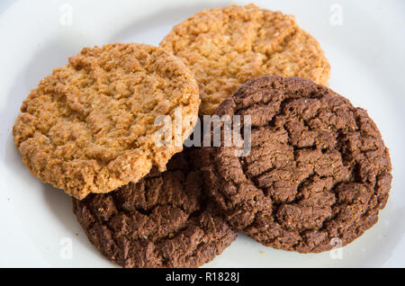 Chocolate and ginger biscuits on a white plate Stock Photo