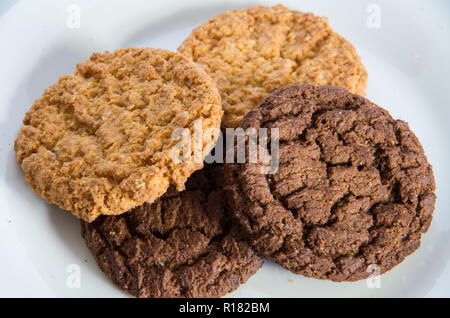 Chocolate and ginger biscuits on a white plate Stock Photo