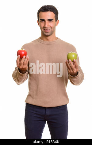 Handsome Persian man holding healthy green and red apple Stock Photo ...