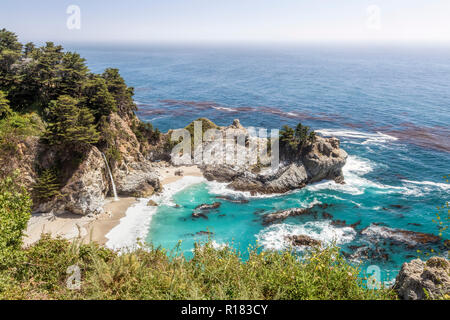 McWay Falls plunges onto a sandy beach in a beautiful rocky cove on the Big Sur Pacific Coast of California. Stock Photo
