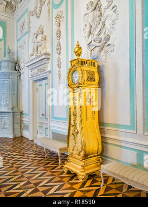 18 September 2018: St Petersburg, Russia - Gilded clock in the Peterhof Grand Palace.