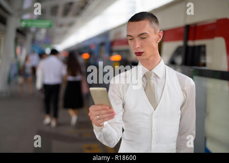 Young androgynous homosexual LGTB businessman wearing lipstick Stock Photo