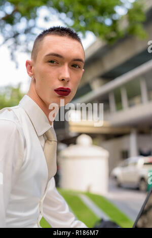 Young androgynous homosexual LGTB businessman wearing lipstick Stock Photo