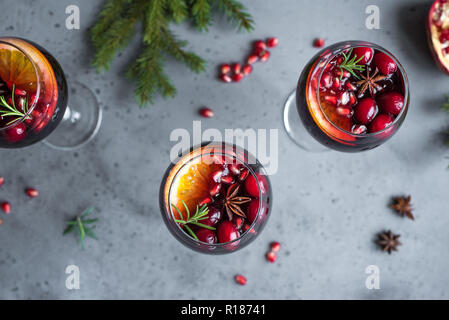 Christmas sangria with oranges, pomegranate seeds, cranberry, rosemary and spices - homemade festive drink mulled wine for Christmas time. Stock Photo