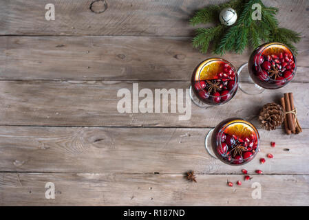 Christmas sangria or Mulled wine with oranges, pomegranate seeds, cranberry and spices - homemade festive drink for Christmas time. Stock Photo