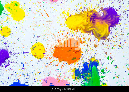 Multicolored watercolor blots isolated on white background. Splashes of a multicolored watercolor paint drops on a white background. Stock Photo