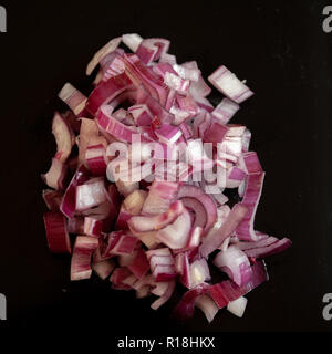 Diced red onion on black background Stock Photo