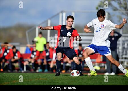 Players battling for possession of the ball near midfield. USA. Stock Photo