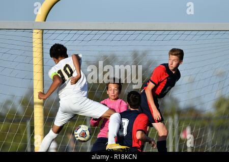 Forward heading in a goal past the opposing keeper. USA. Stock Photo