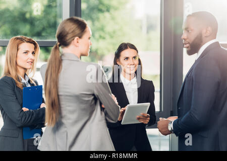 multiethnic business colleagues having conversation in office Stock Photo
