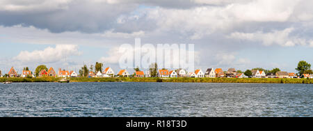 Skyline of dike village Durgerdam with row of old houses and boats, IJmeer, Amsterdam, North Holland, Netherlands Stock Photo