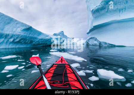 Kayaking in Antarctica between icebergs with inflatable kayak, extreme adventure in Antarctic Peninsula , beautiful pristine landscape, sea water padd Stock Photo