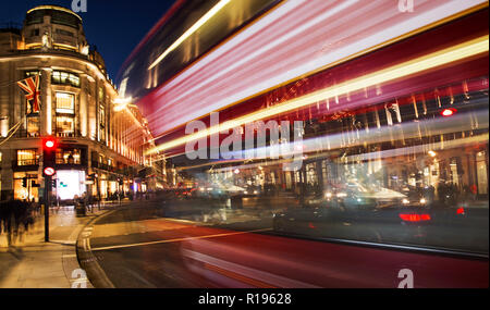 night scene of London city with moving red bus and cars - long exposure photography Stock Photo