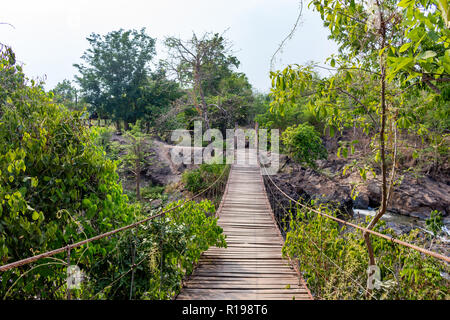Don Khone, Laos - April 23, 2018: Hanging wooden bridge on the Four Thousand Islands zone near the border between Laos and Cambodia Stock Photo