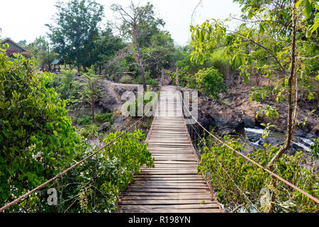Don Khone, Laos - April 23, 2018: Hanging wooden bridge on the Four Thousand Islands zone near the border between Laos and Cambodia Stock Photo