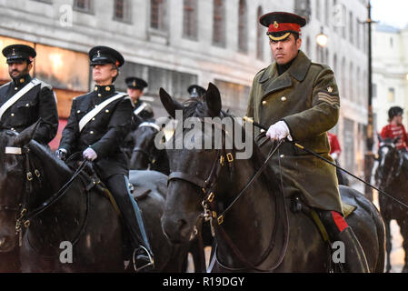 Mounted riders of British Army Royal Yeomanry getting caught in heavy rain after the Lord Mayor's Show Parade while returning to barracks. Wet coat Stock Photo