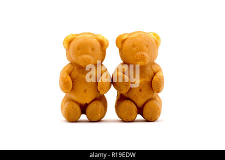 Sweets in the form of teddy bears with condensed milk isolated on a white background Stock Photo