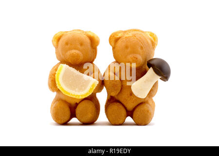 Sweets in the form of bears with condensed milk isolated on a white background Stock Photo