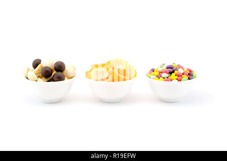 Three bowls of sweets and chocolate jelly mushrooms isolated Stock Photo